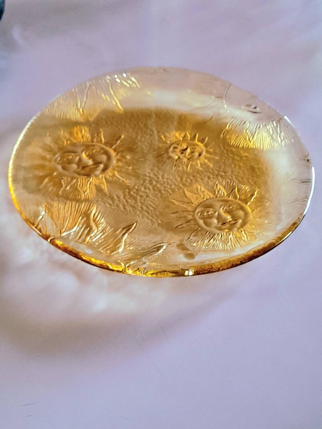 Glass plate decorated with suns, 1980.