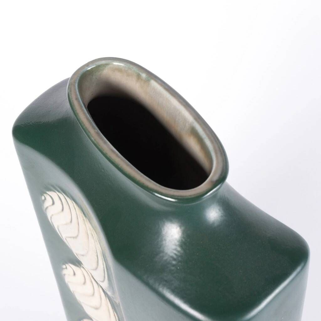 A tall ceramic vase glazed with dark green colour