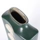 A tall ceramic vase glazed with dark green colour
