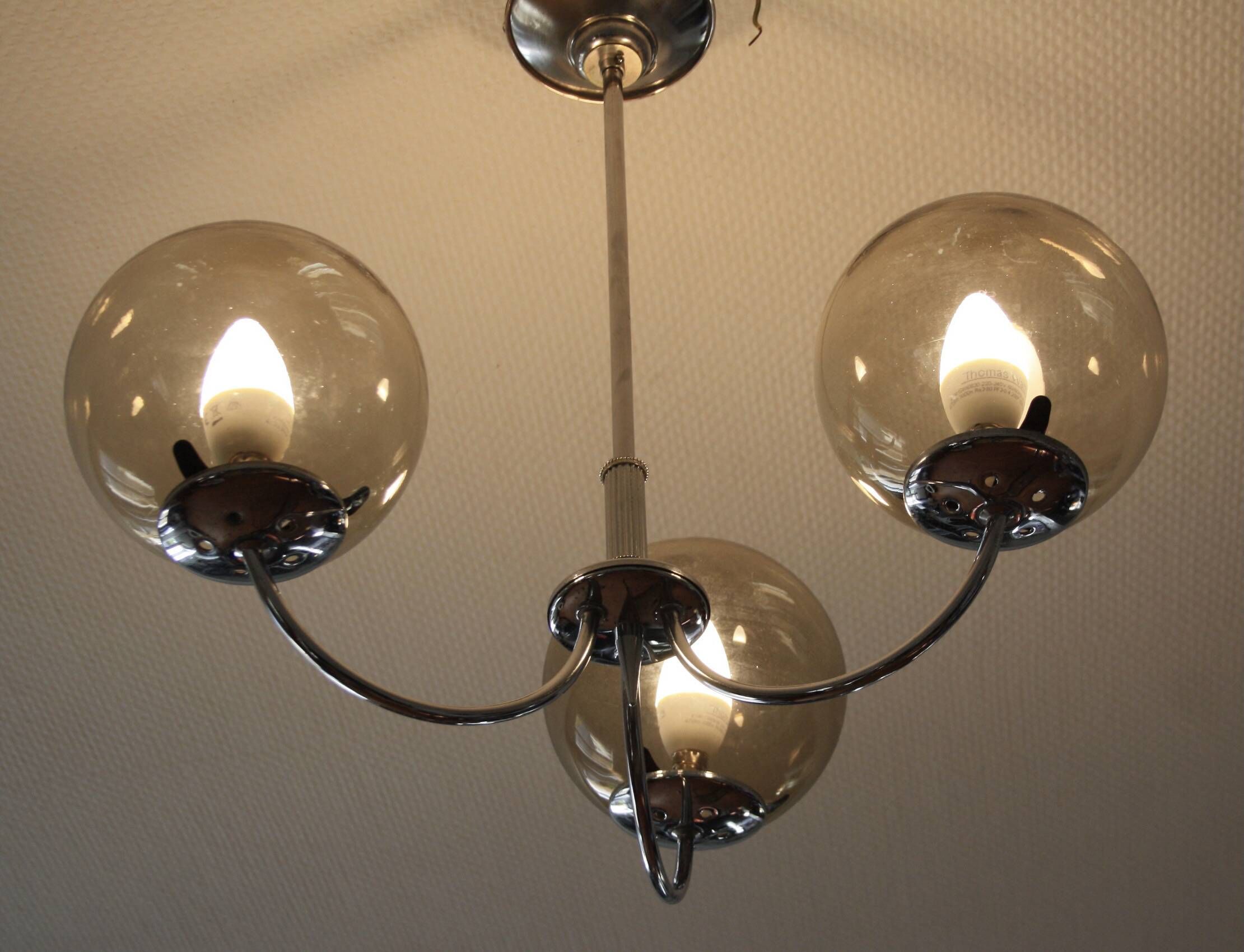 Chrome metal chandelier with smoked glass globes.