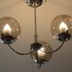 Chrome metal chandelier with smoked glass globes.