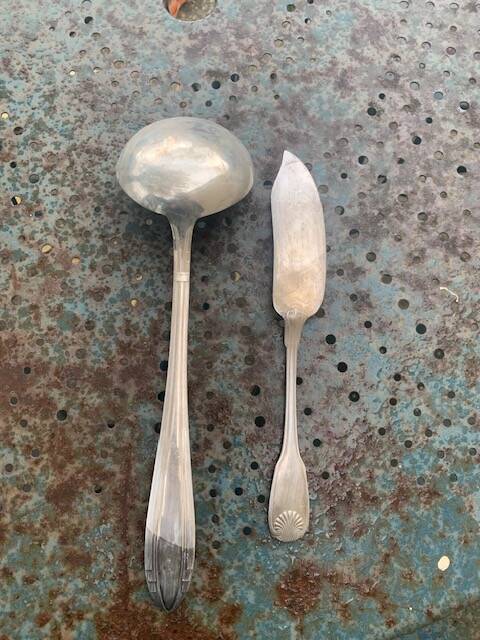 Lot of mismatched silver metal serving cutlery, a ladle and a fish knife