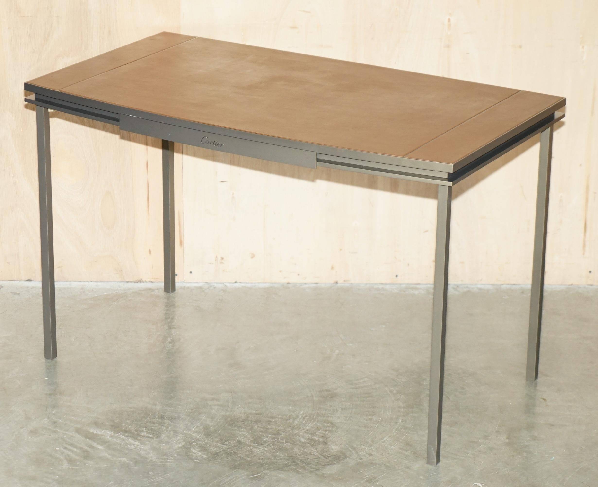 Modern mid-century writing desk signed Cartier in bronze and leather.