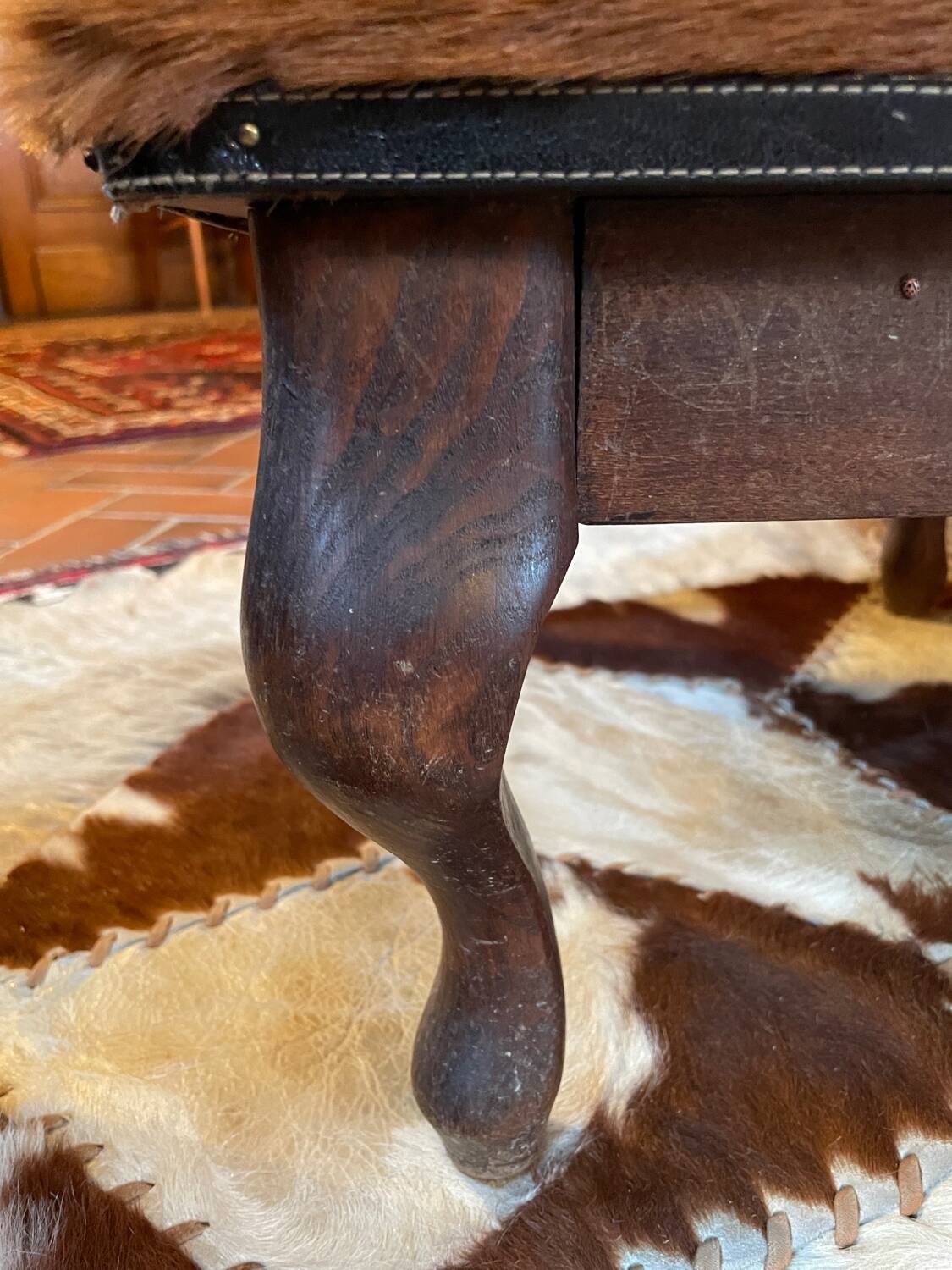 Vintage wooden and goatskin pouf