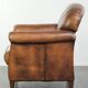 Comfortable characterful sheepskin armchair finished with decorative nails