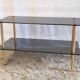 Coffee table in gilded metal and smoked glass – 60s