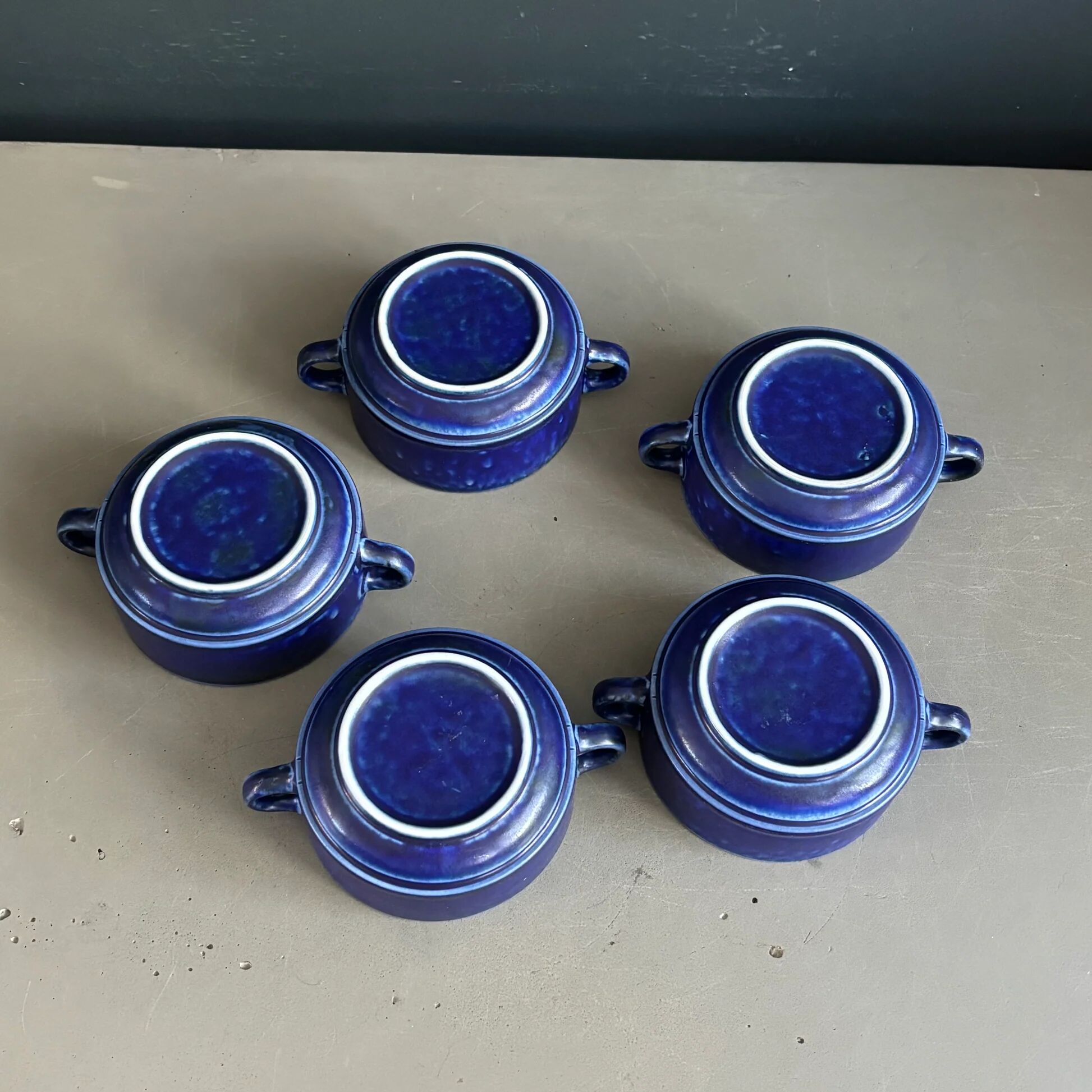 Set of 5 blue Klein ceramic tea cups with saucers.