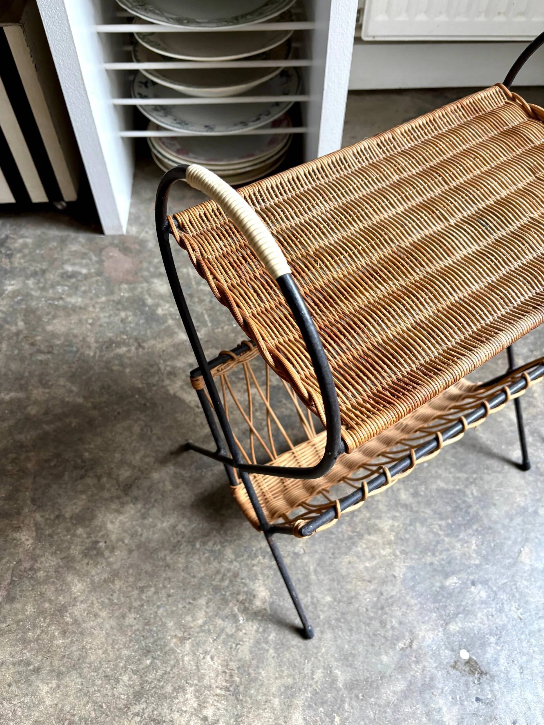 Black metal and woven wicker magazine rack