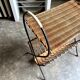Black metal and woven wicker magazine rack