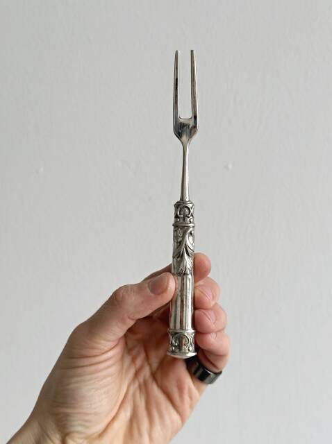 Antique shiny metal cheese cutlery