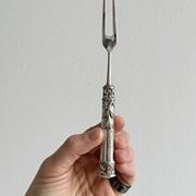 Antique shiny metal cheese cutlery