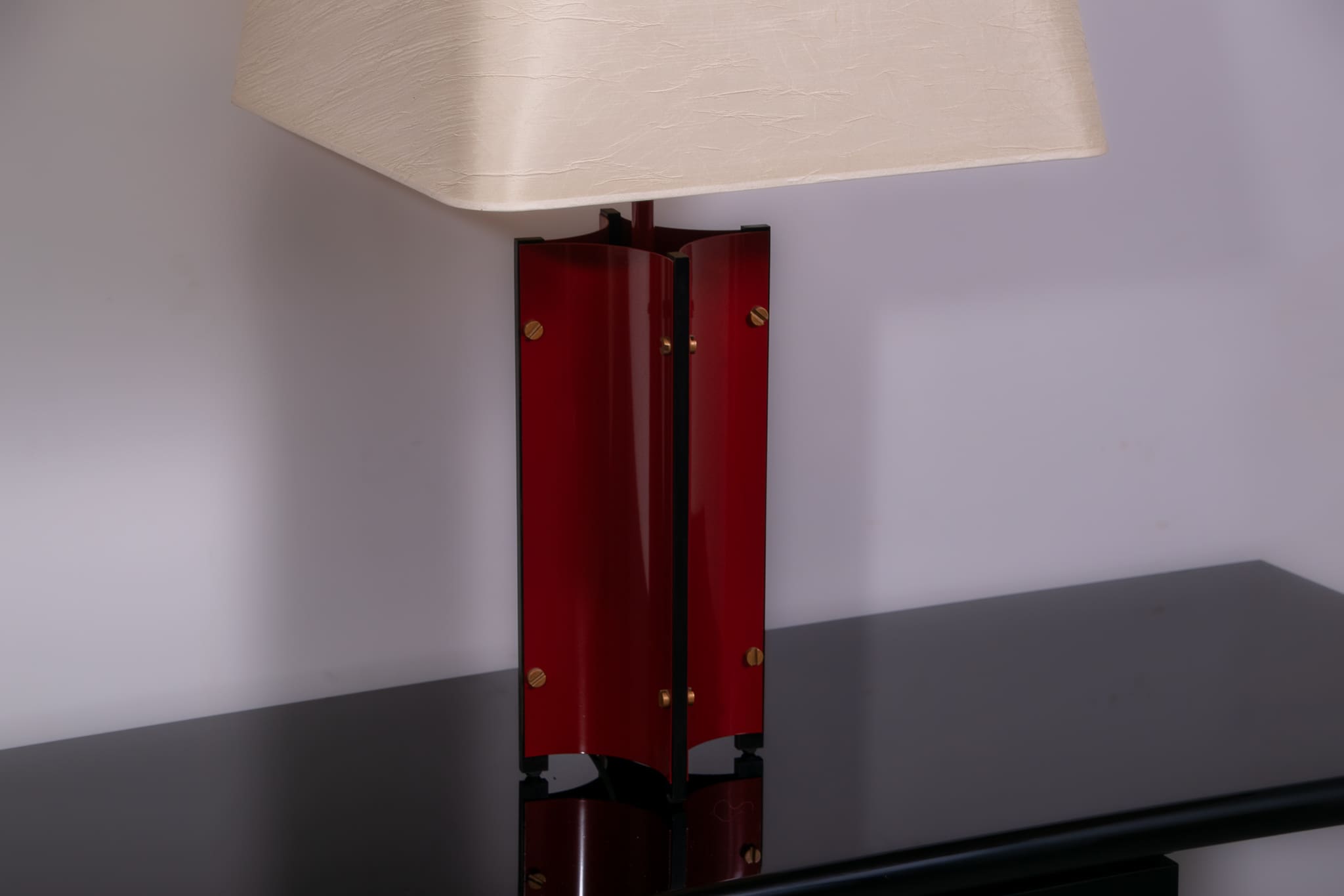 Red metal sculptural table lamp with oversized lamp shade circa 1980