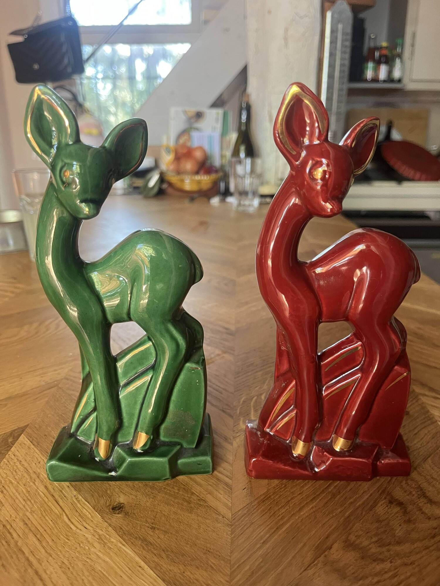 Pair of Art Deco deer by Charles Lemanceau in red and green ceramic.