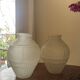 2 semi-opaque glass vases with relief bird designs.