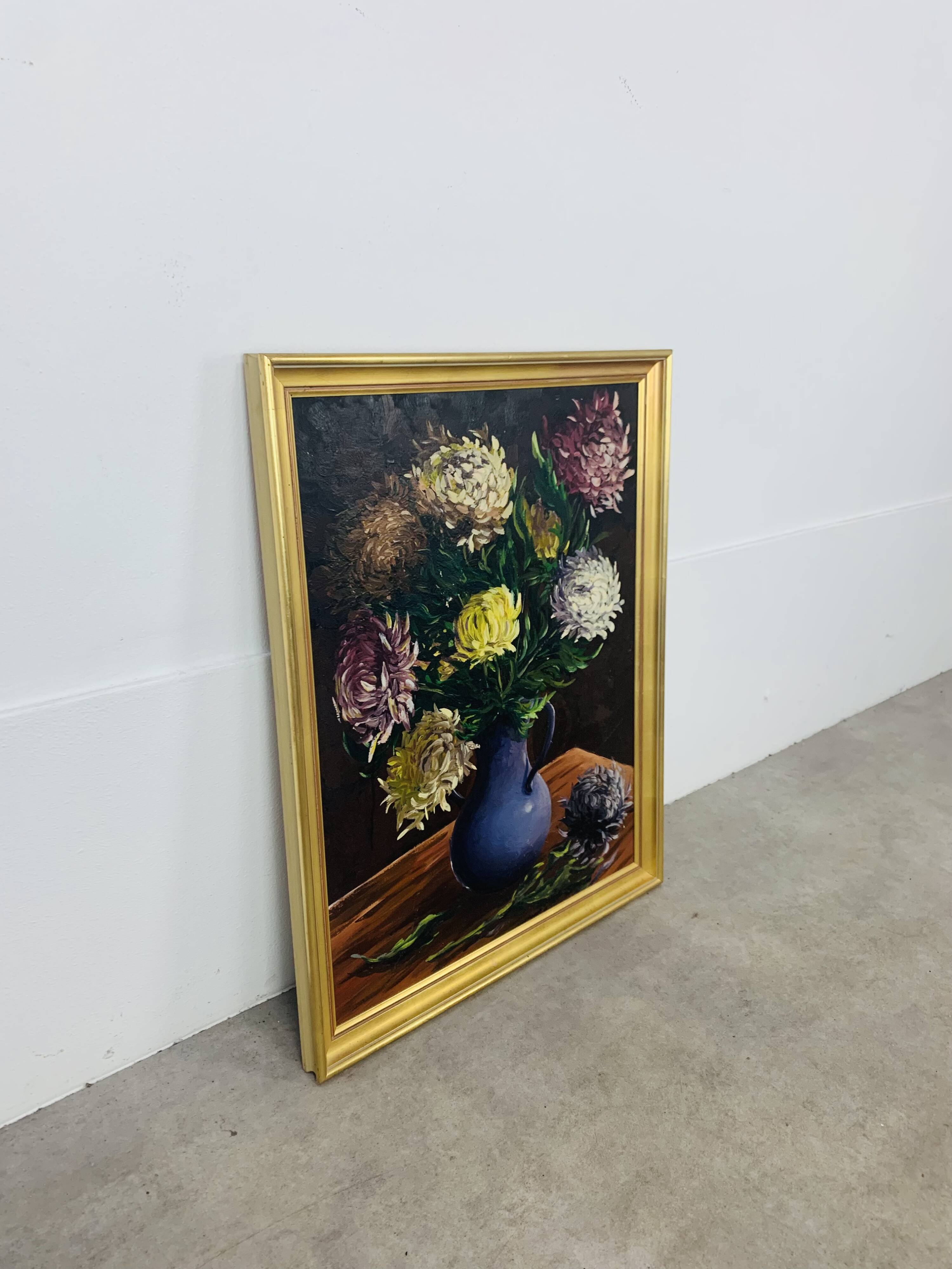 Still life painting of a bouquet of flowers, golden frame