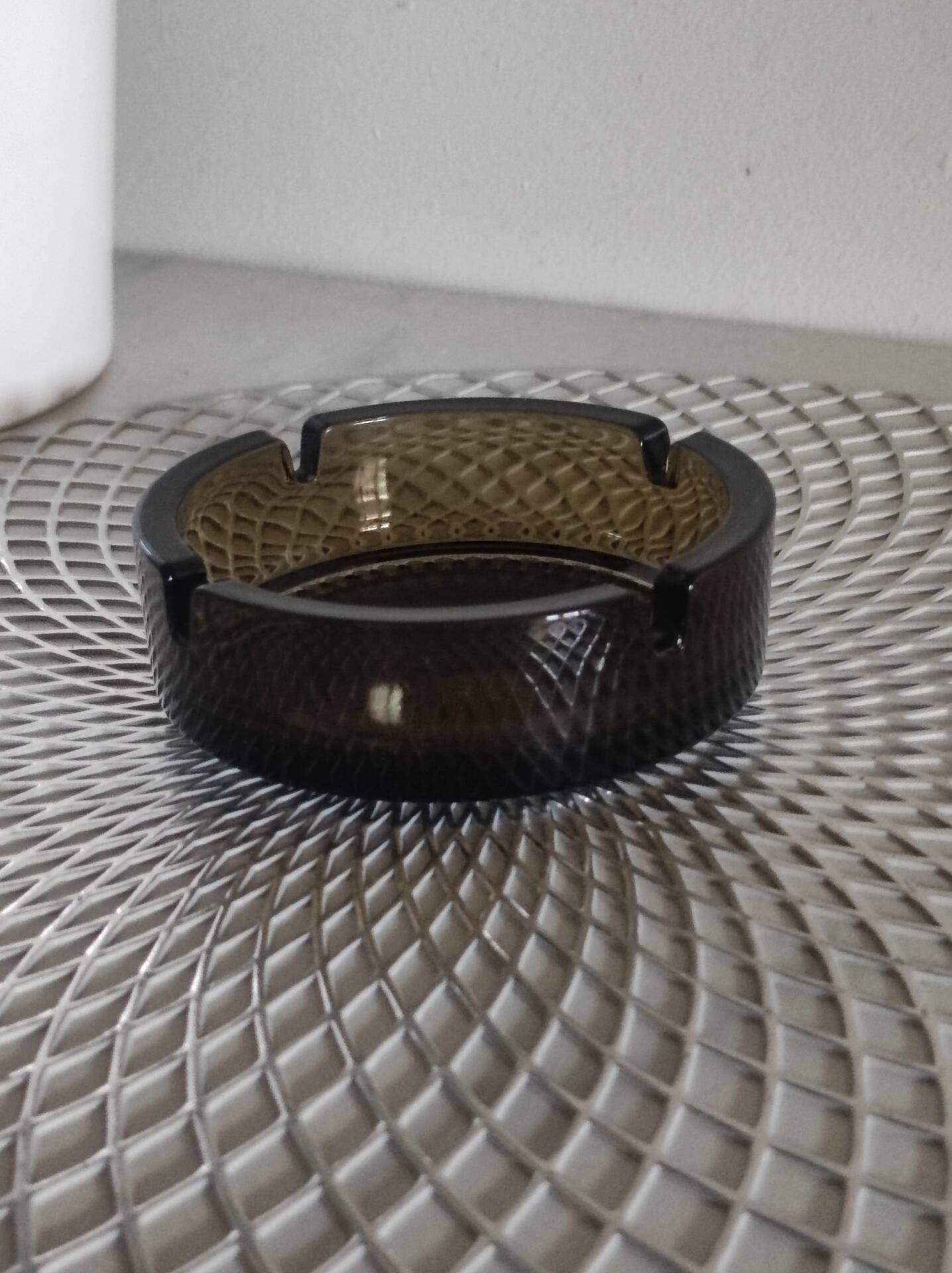 Dark smoked glass ashtray from the 1970s.