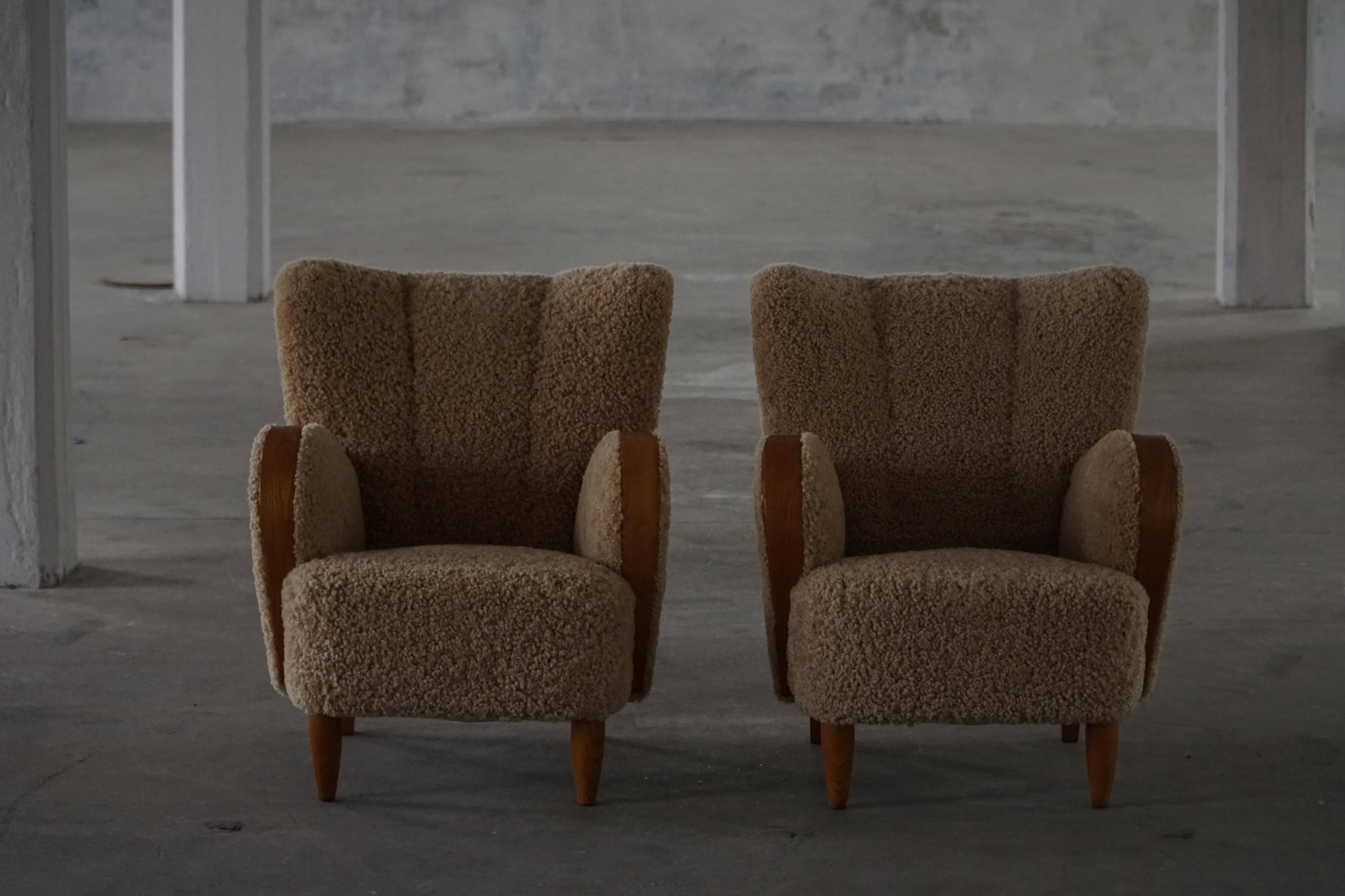 Pair of Danish Art Deco modern lounge chairs in sheepskin with lambswool and elm, 1940s.