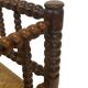 Vintage 'bobbin' bench with a rush seat, 1920s design with armrests.