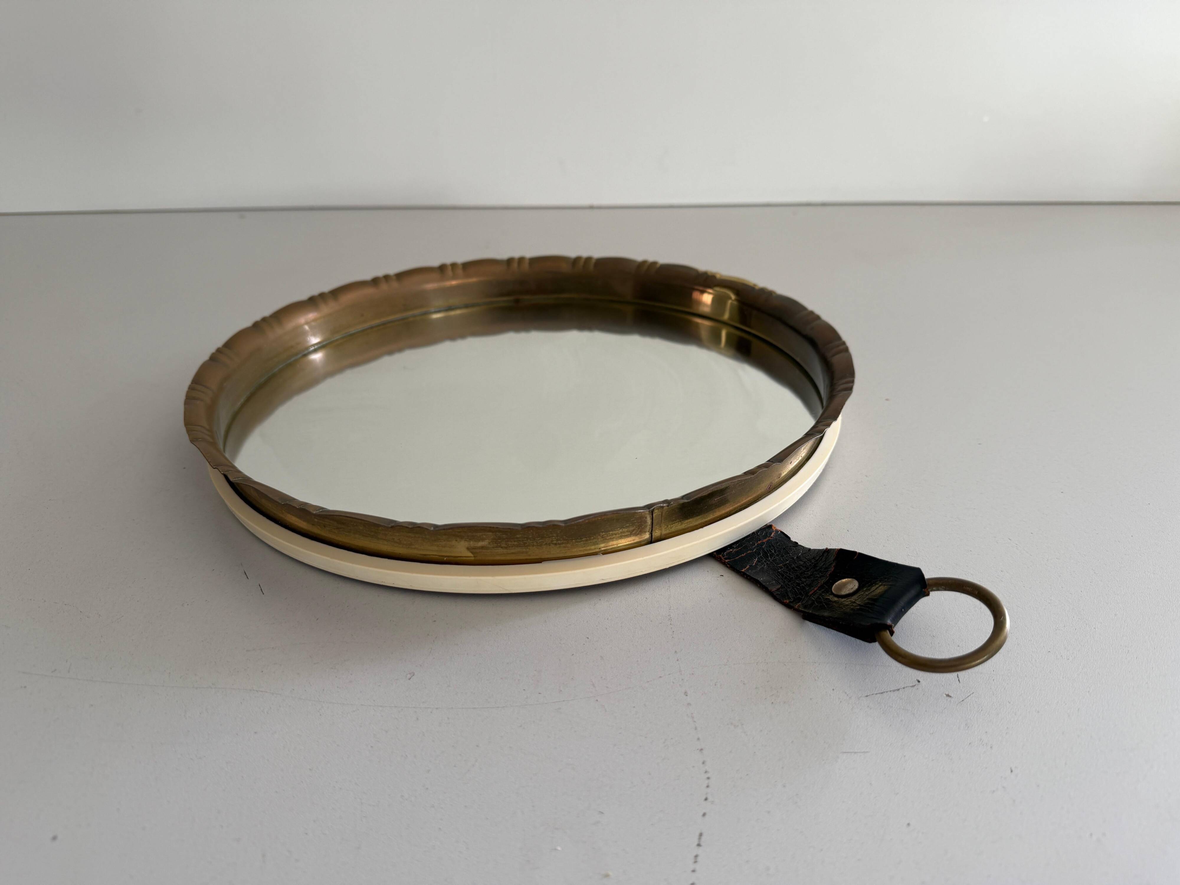 Round wall mirror with brass frame and leather hanger, 1960, Germany