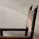 Antique armchair in walnut and studded leather, 17th century