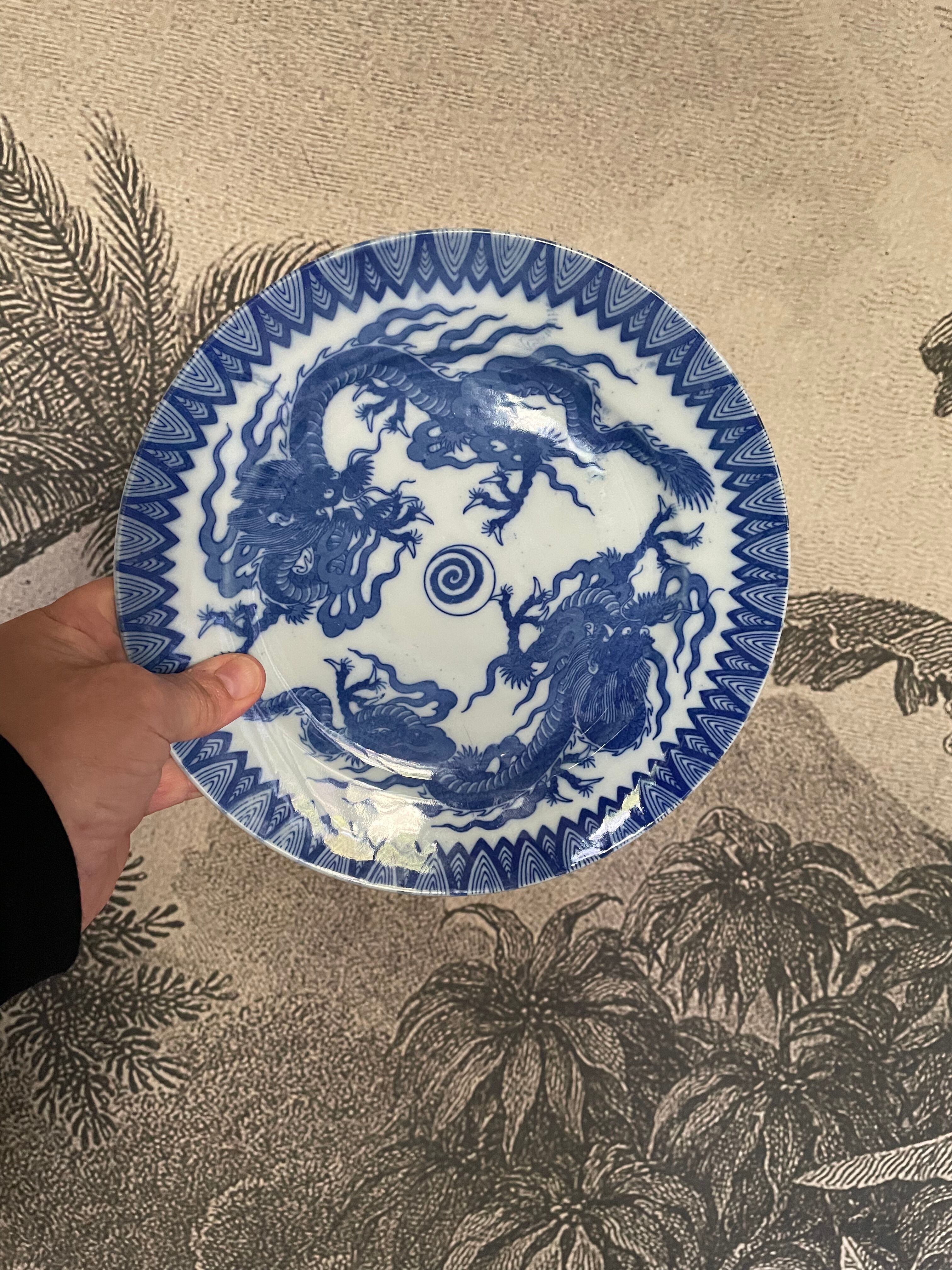 Asian porcelain plates decorated with blue dragons
