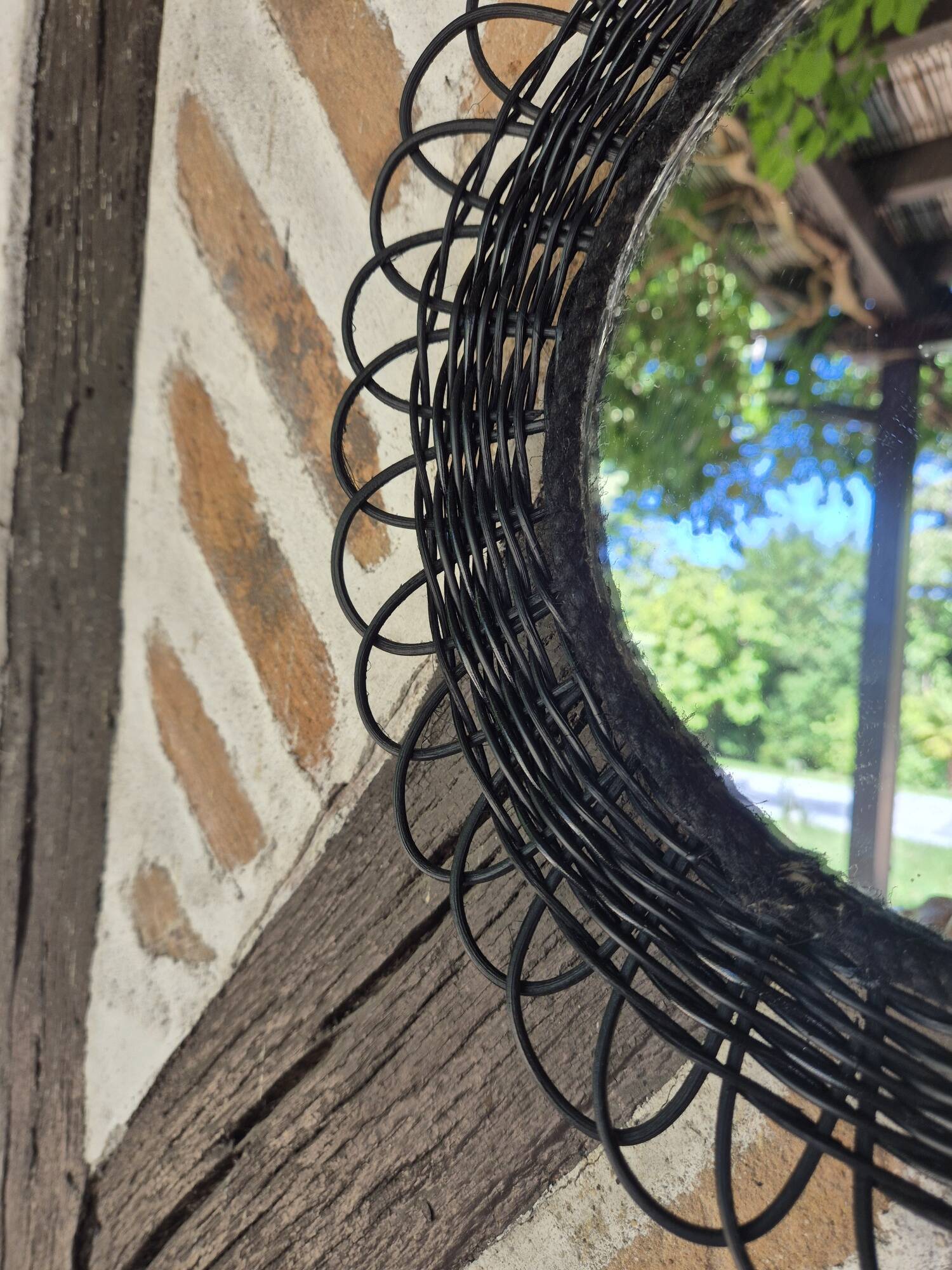 Vintage black rattan flower mirror