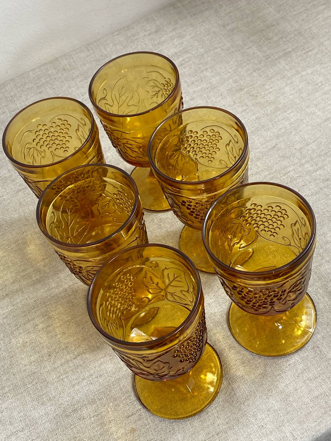 Six stemmed glasses in amber-colored molded glass
