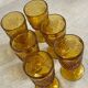 Six stemmed glasses in amber-colored molded glass