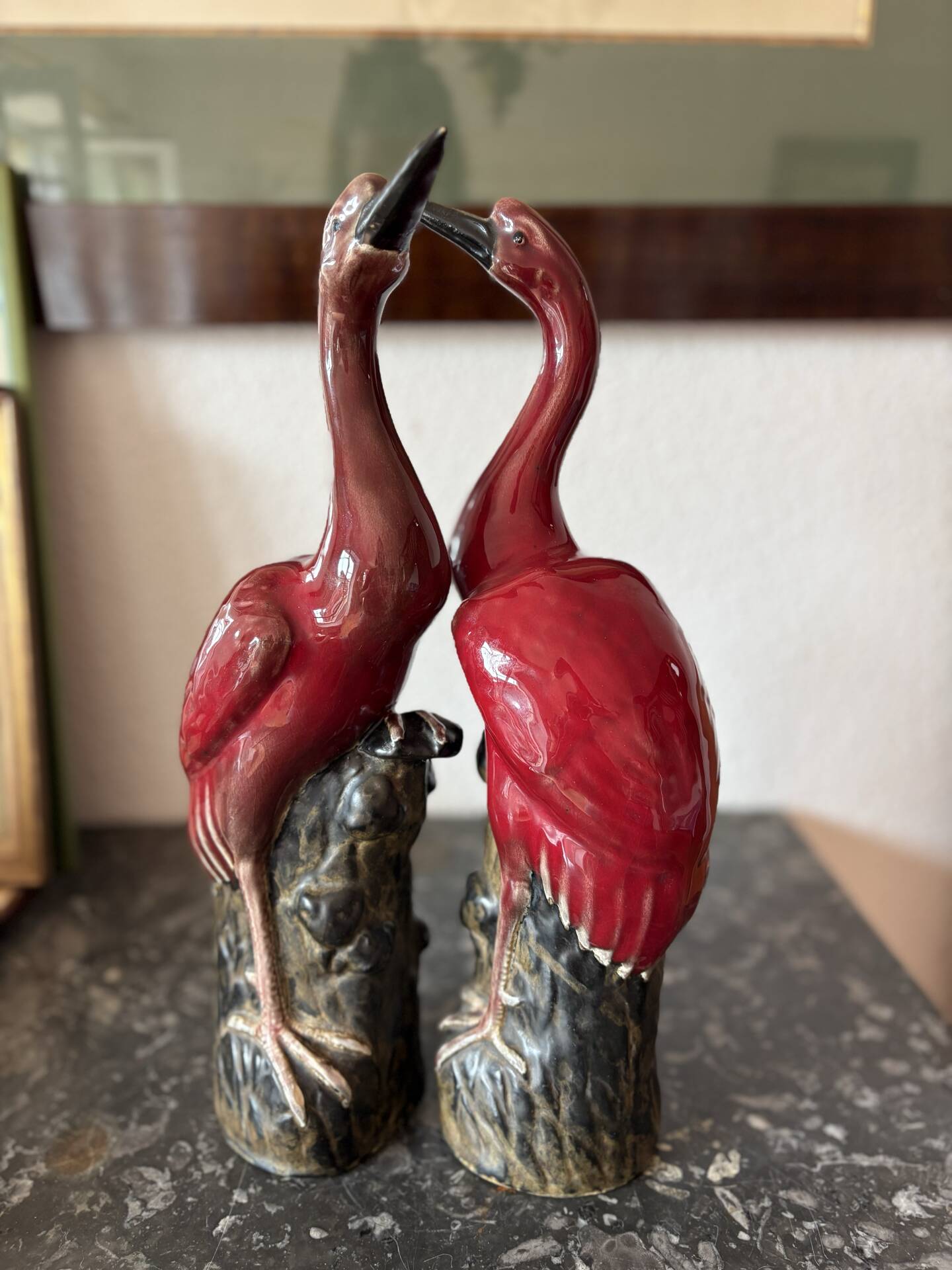 Pair of ceramic red glazed wading bird (crane) figurines.