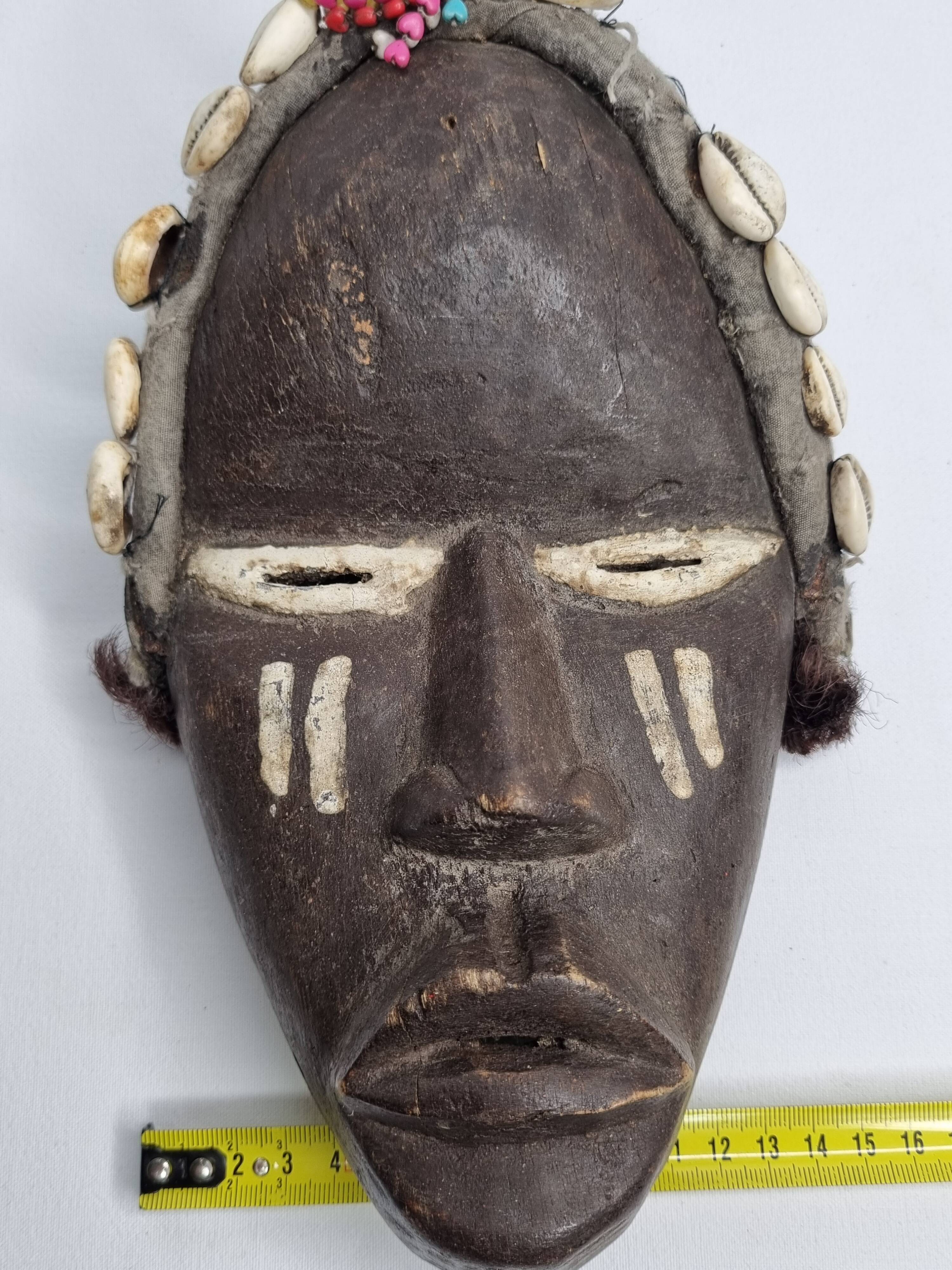 Tribal Dan mask in wood and cowrie shells, West Africa, 27 cm