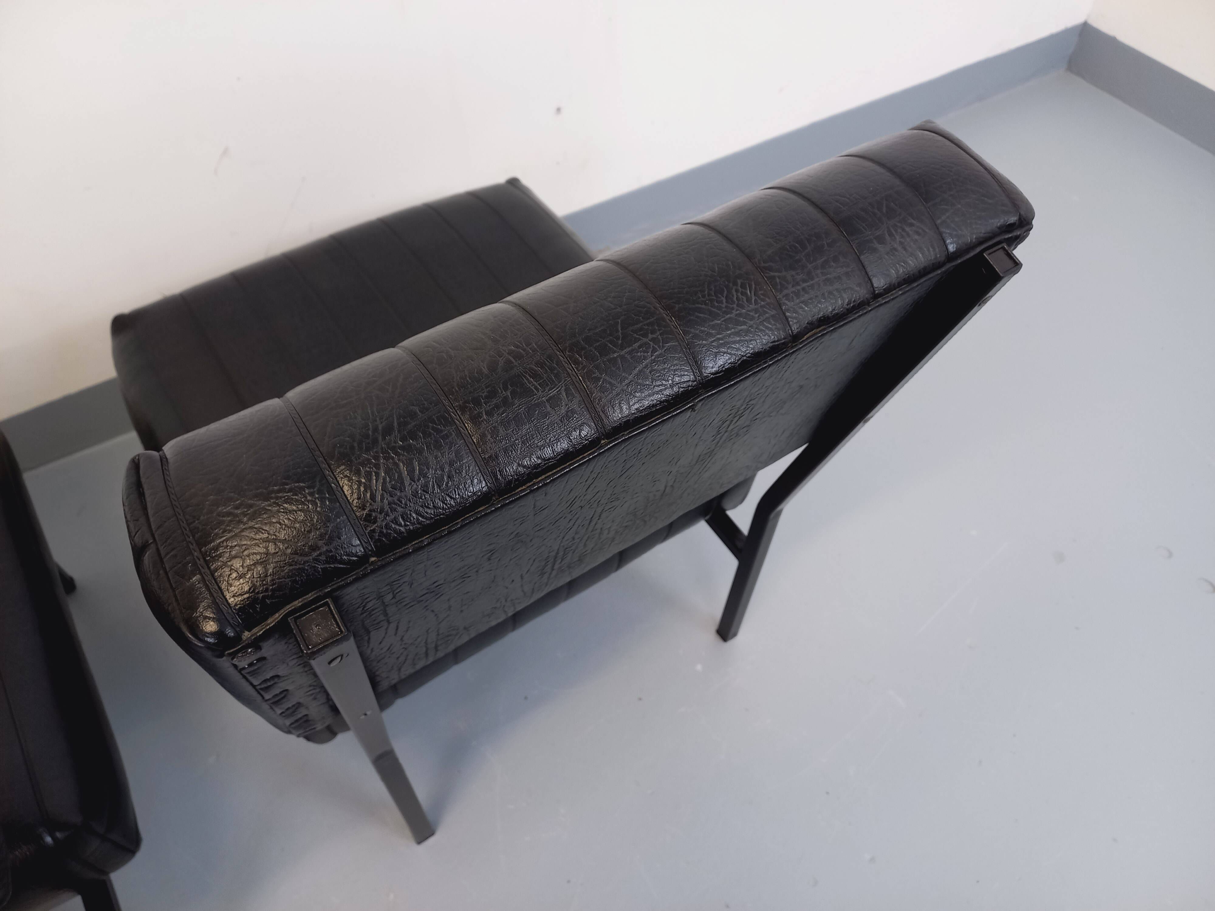 Set of 2 vintage modernist armchairs in black faux leather and metal.