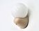 Beige Tissot wall light with opaque white glass globe, 1970s 80s.