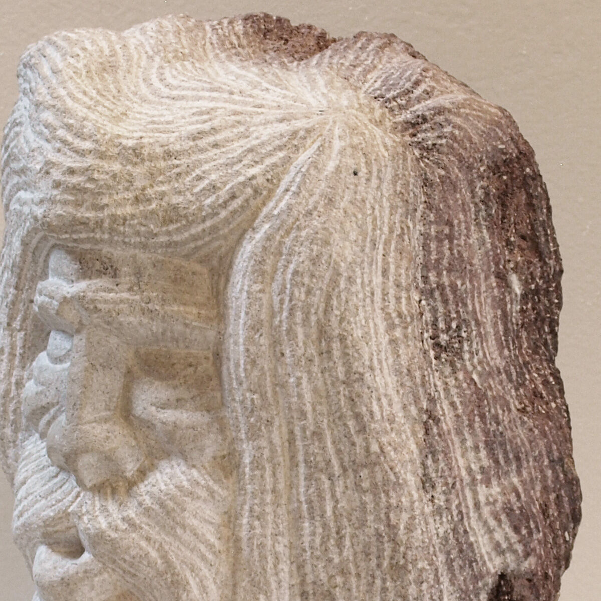 Carved stone head sculpture