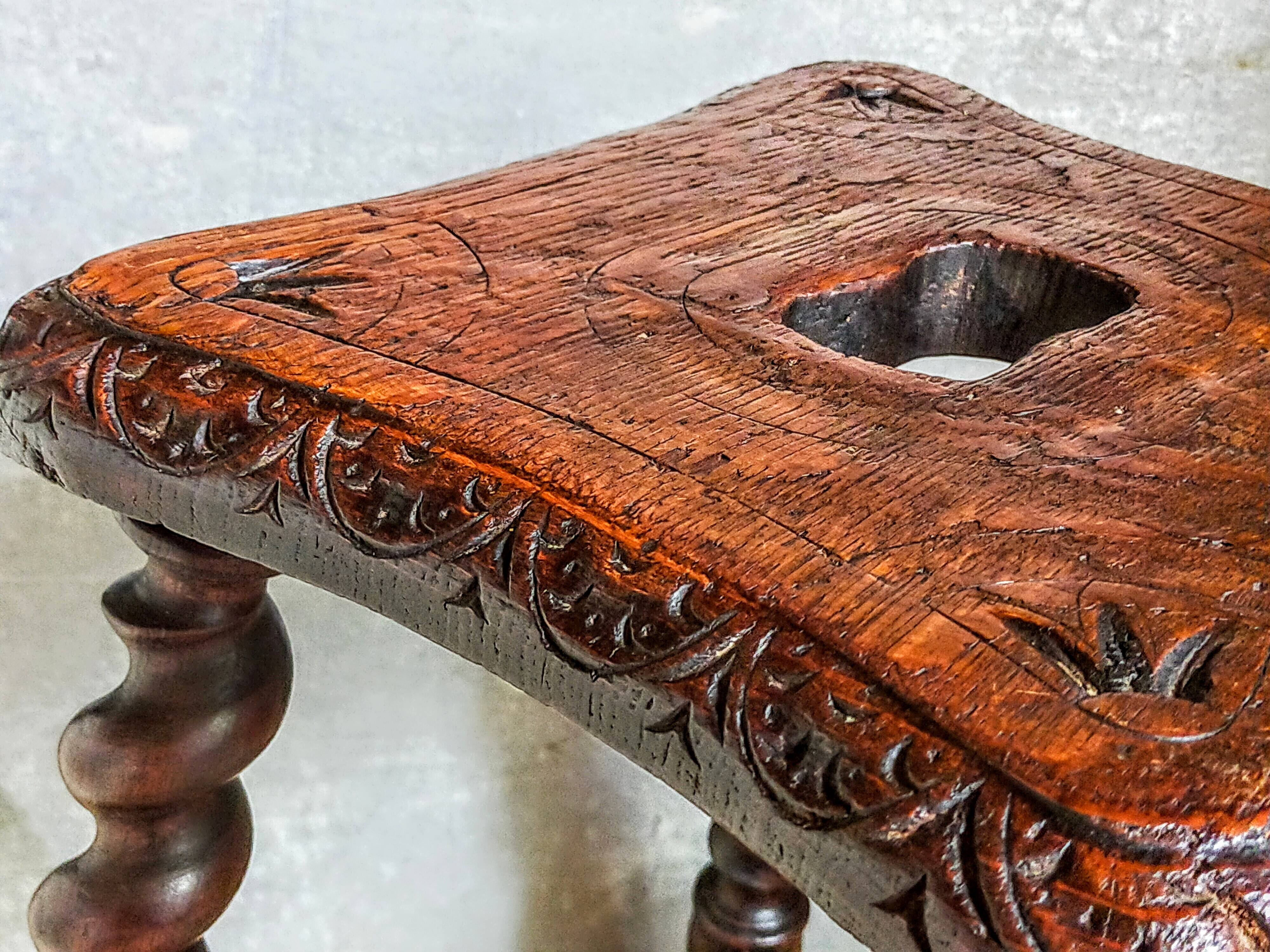 Antique stool in turned and carved solid wood