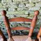 Set of 4 solid wood chairs with straw seats.