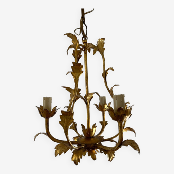 Golden metal chandelier with leaf decoration
