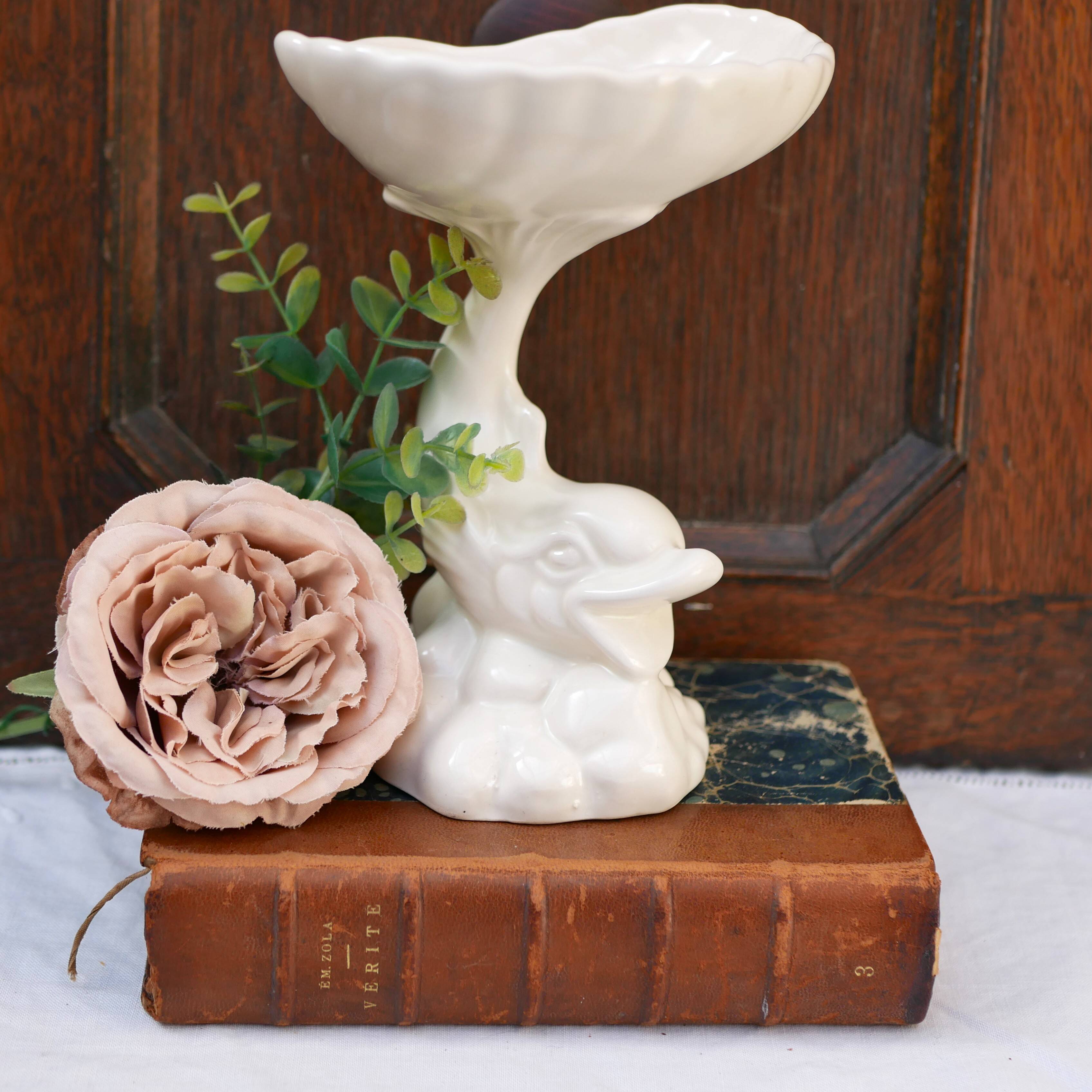 Dartmouth pottery koi carp supporting a shell-shaped dish/vase.