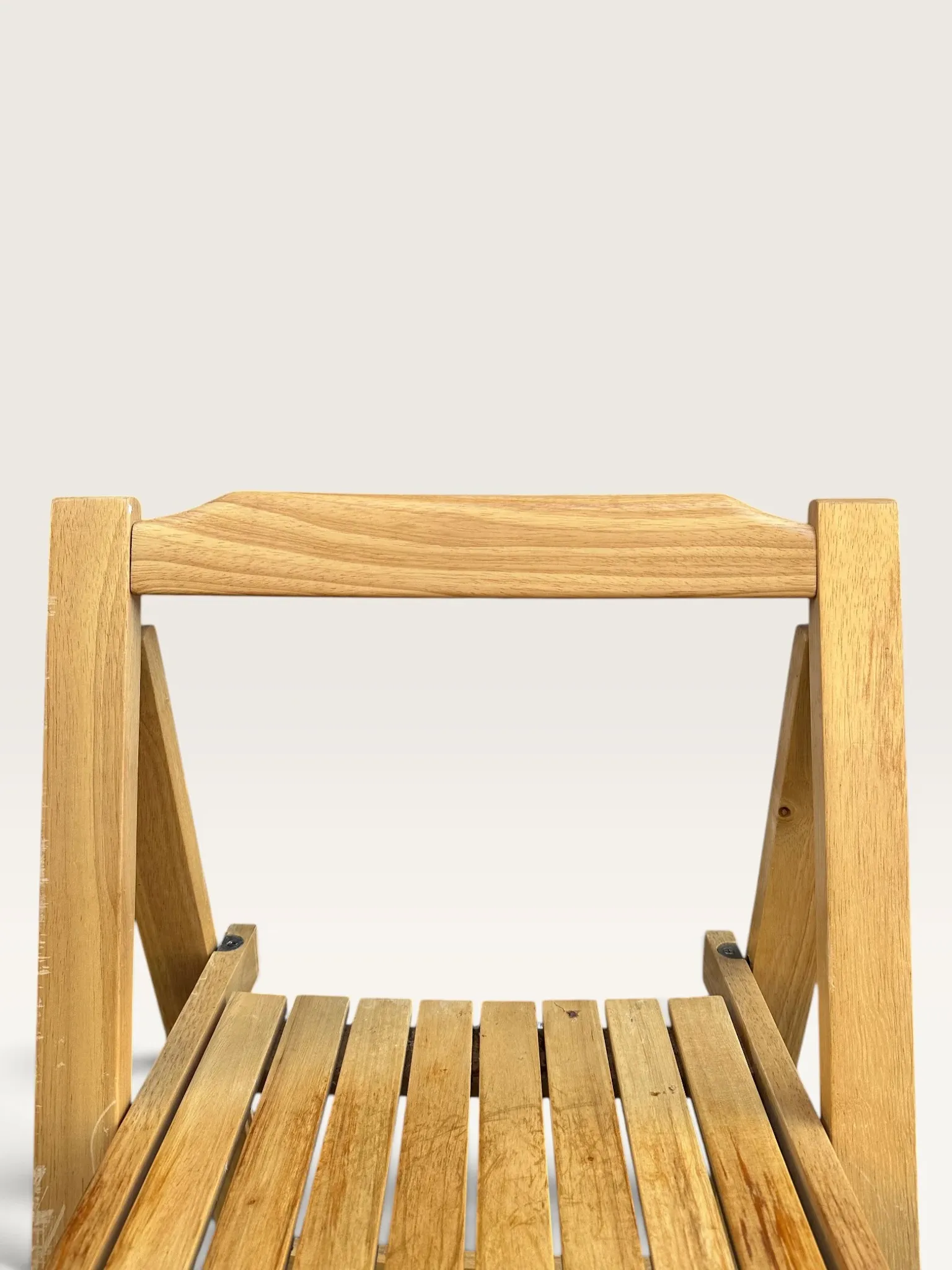 Blonde wooden folding chair in the style of Aldo Jacober.