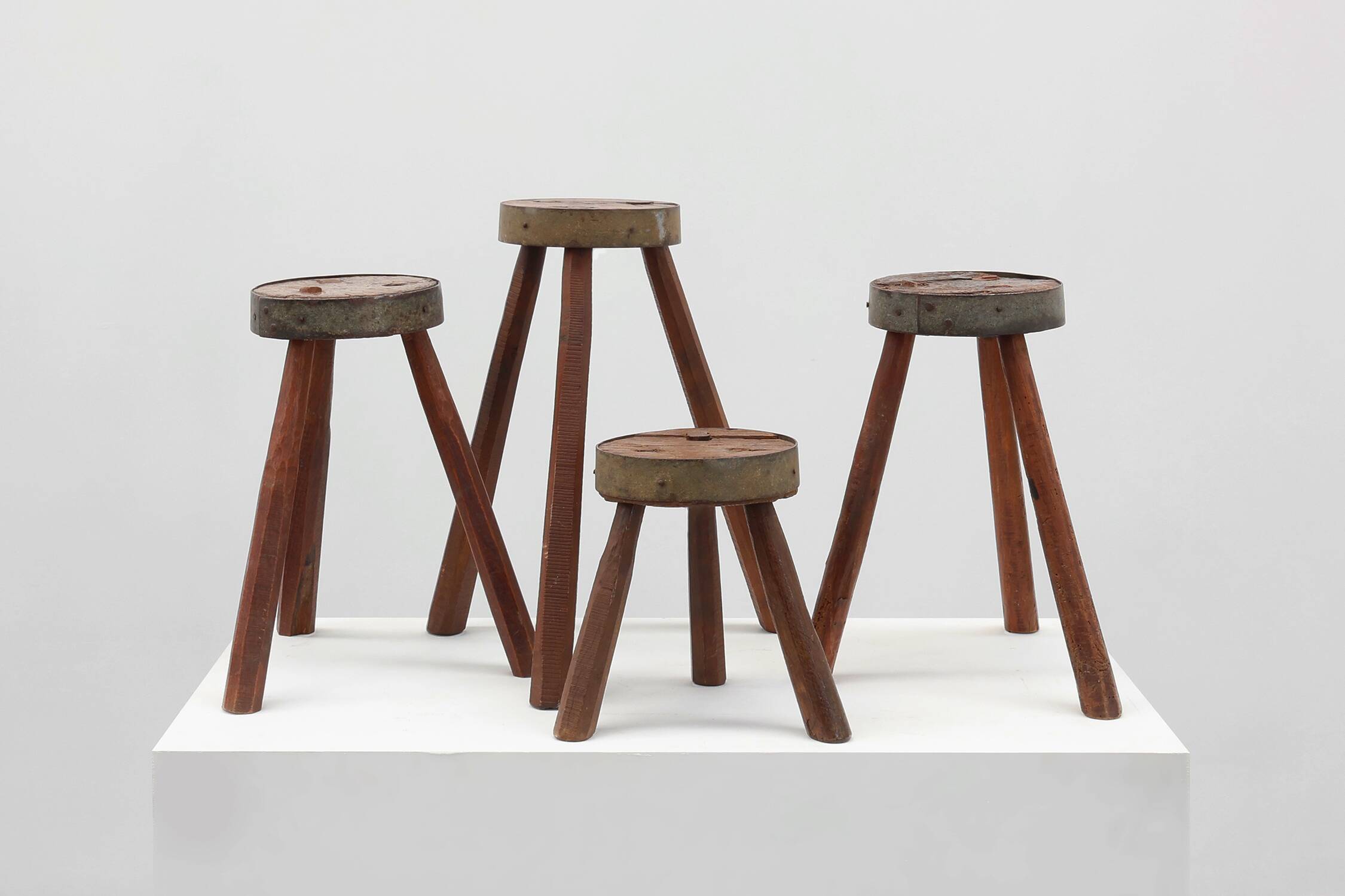 Brutalist French 1850s solid oak tripod stools with metal rim, set of 4