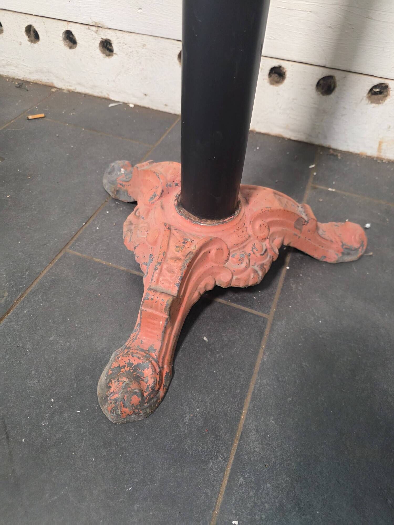 Bistro standing table with marble top and cast iron base.