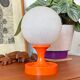 Orange vintage space age eyeball table lamp with a glass globe