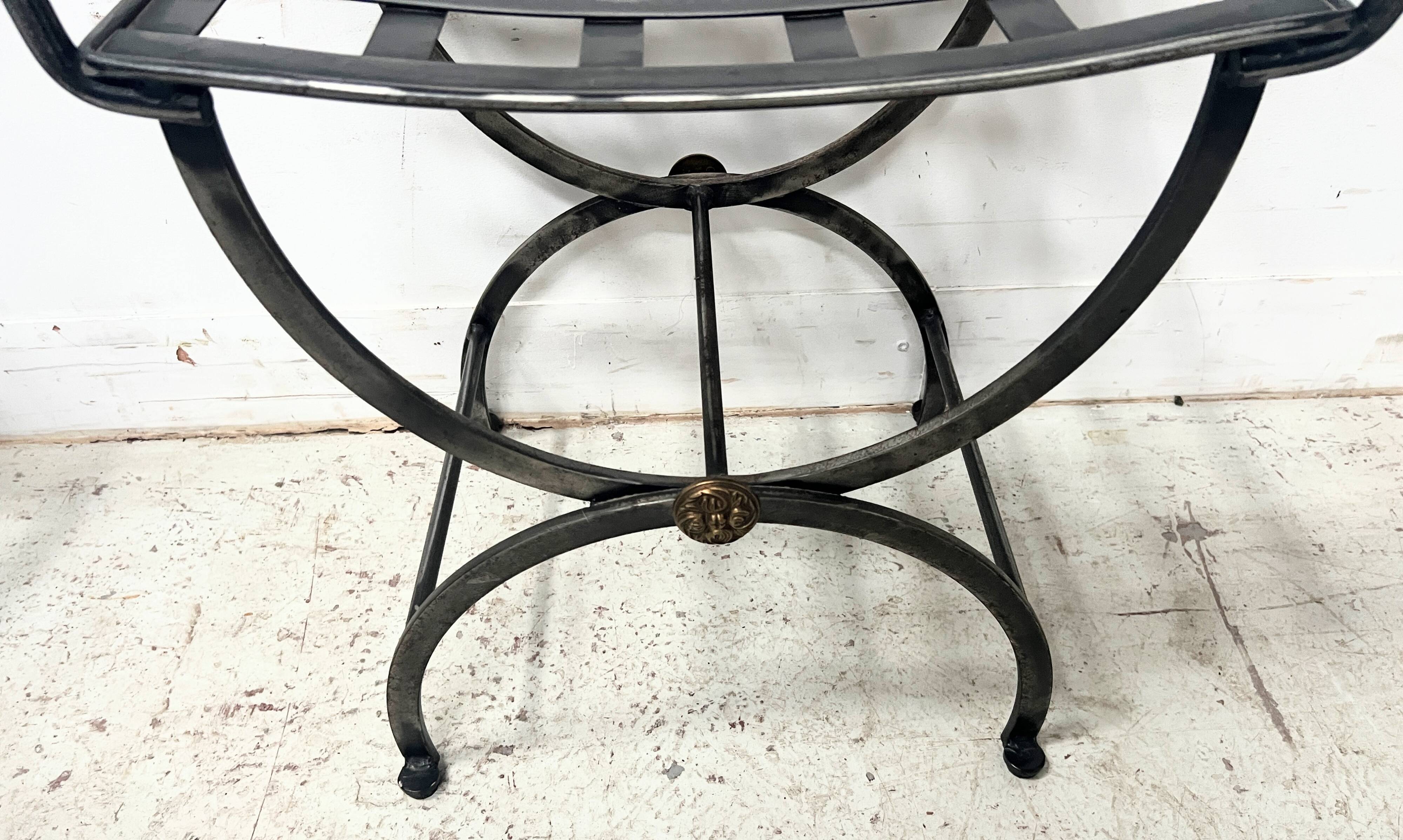 Set of four wrought iron chairs, with a reclining X-shaped base, seat and backrest.