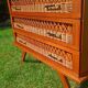 Rattan and wood splayed-leg chest of drawers