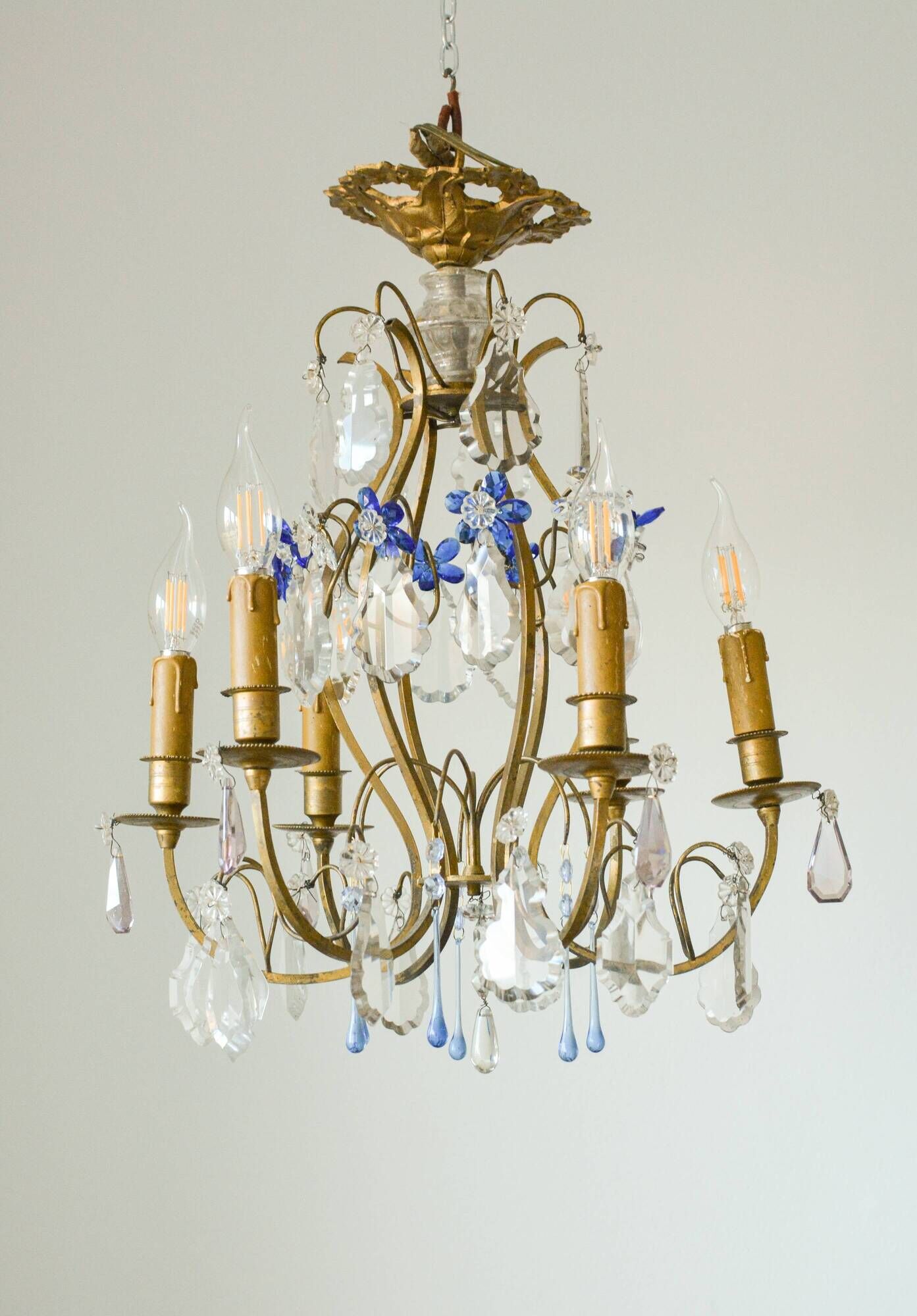 Antique French chandelier cage in gilded bronze and crystal, with blue pendants.