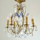 Antique French chandelier cage in gilded bronze and crystal, with blue pendants.