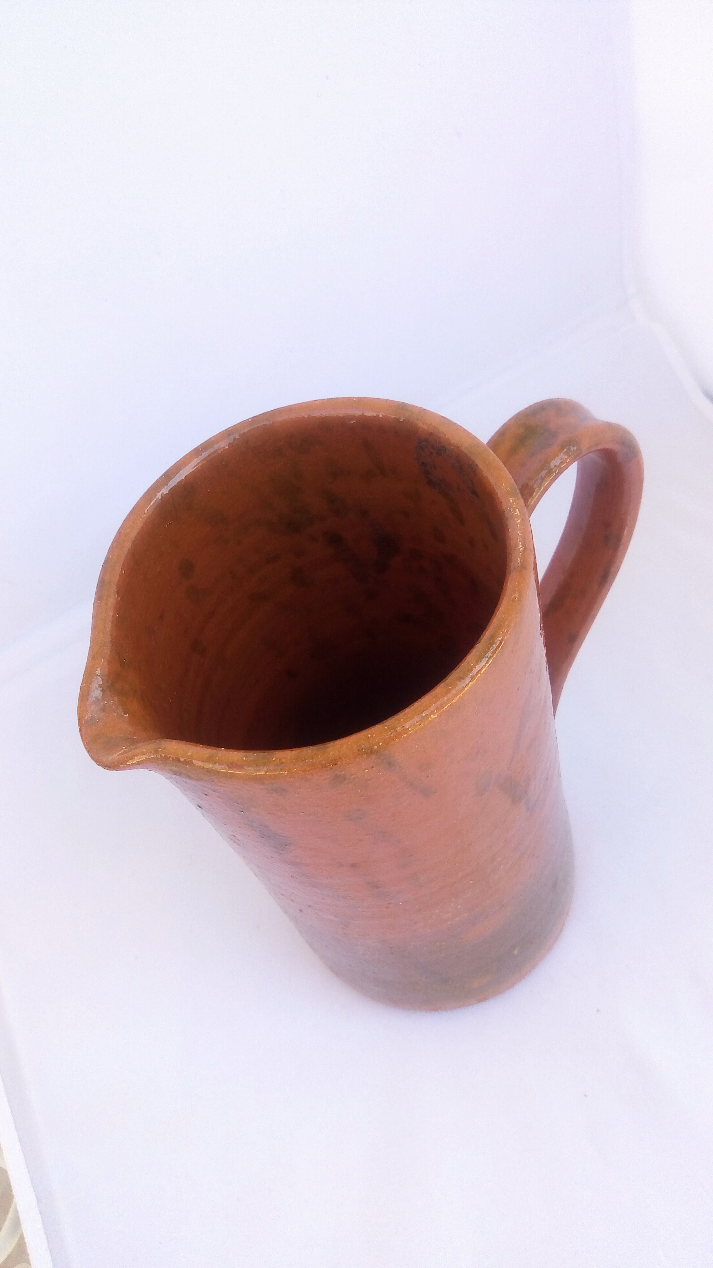 Brown and khaki green varnished earth pitcher