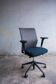 Vitra ID Trim office chair by Antonio Citterio — black mesh backrest and blue fabric seat, aluminium frame.