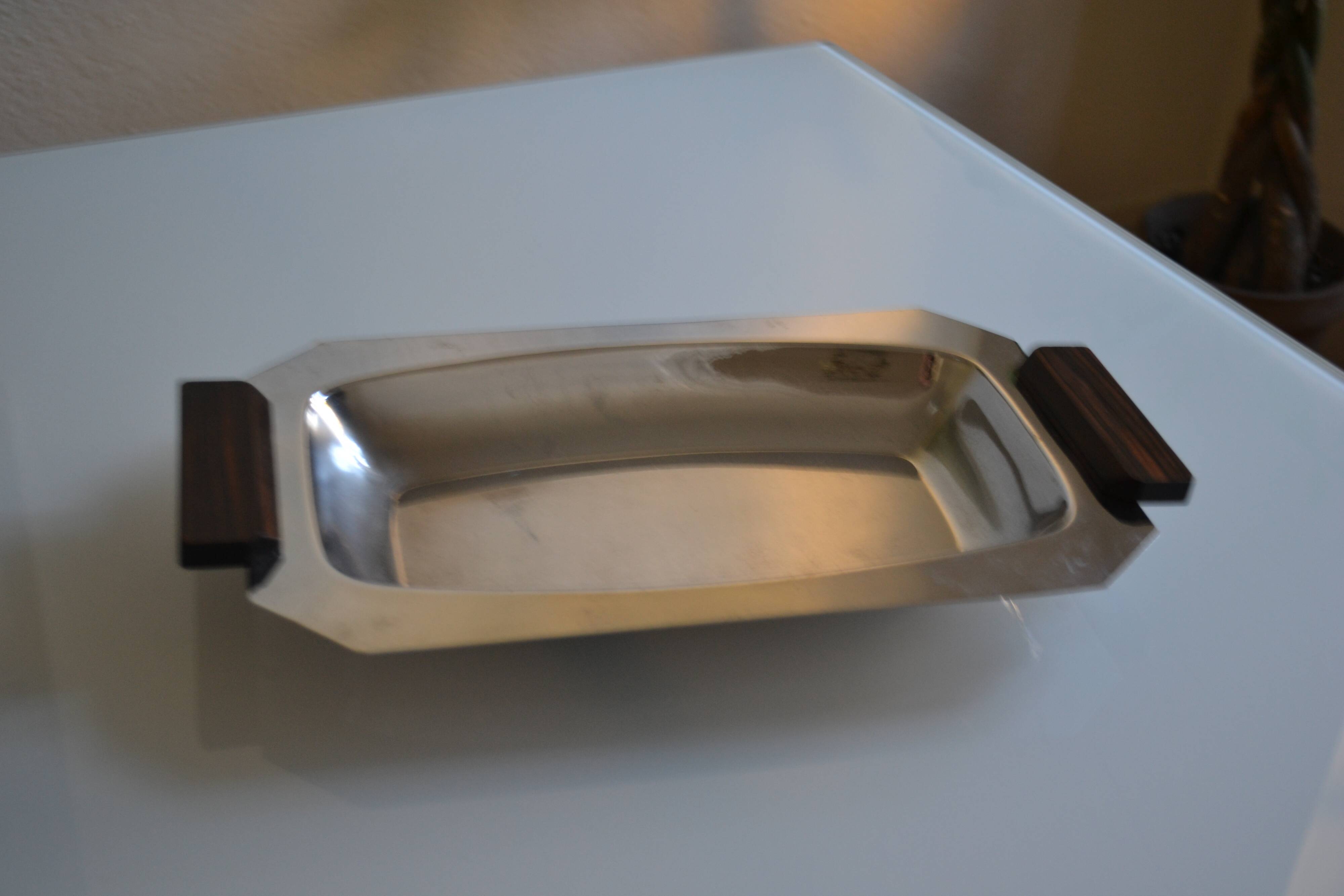 Art Deco serving dish in chrome metal with ebony handles.