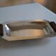 Art Deco serving dish in chrome metal with ebony handles.
