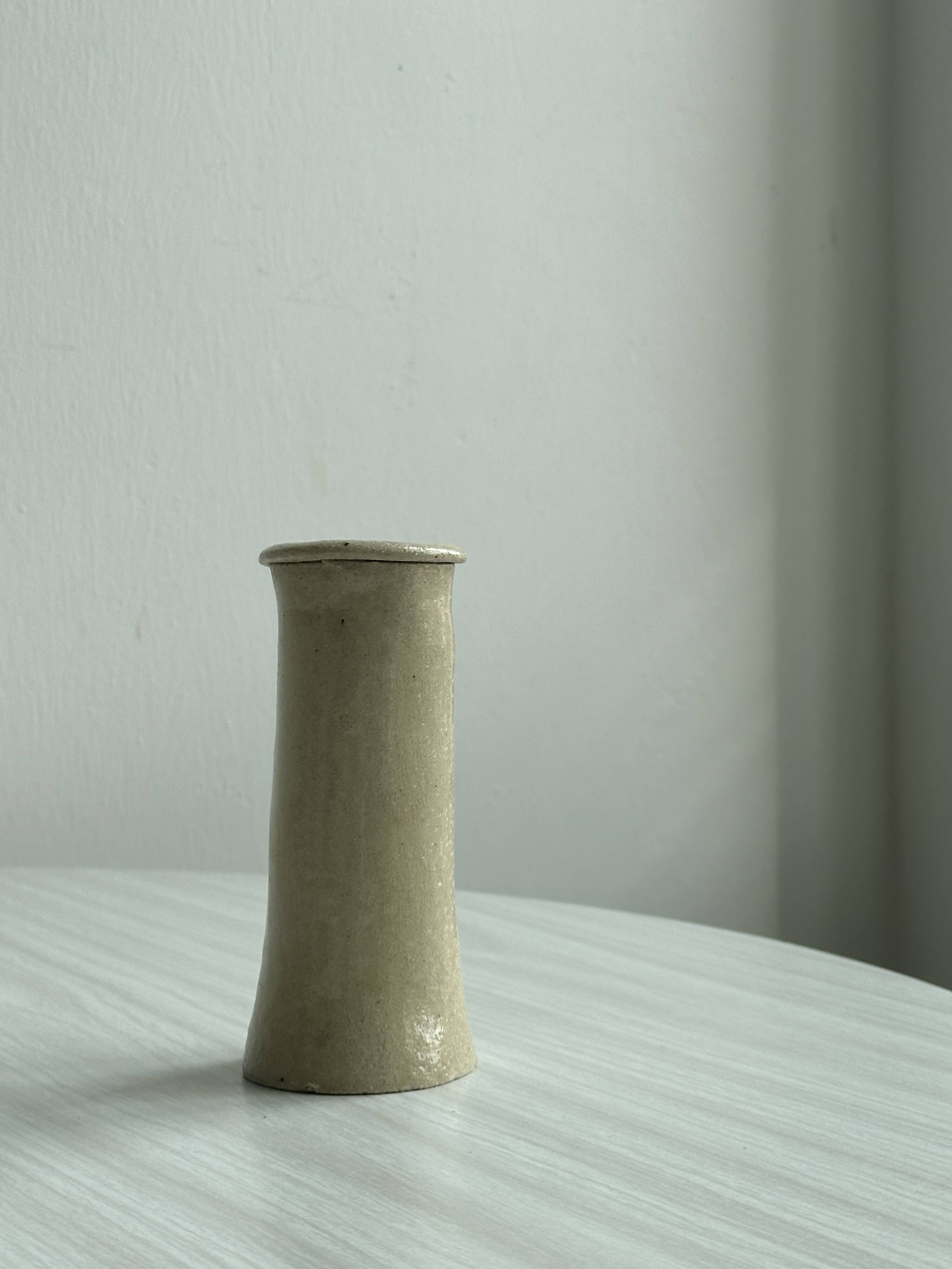 Minimalist beige ceramic vase.